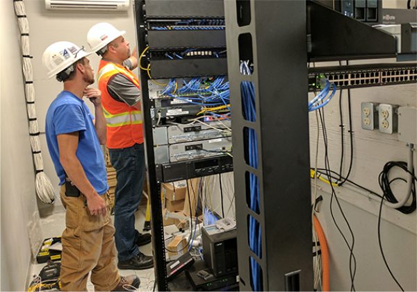 employees working on cabling at a business