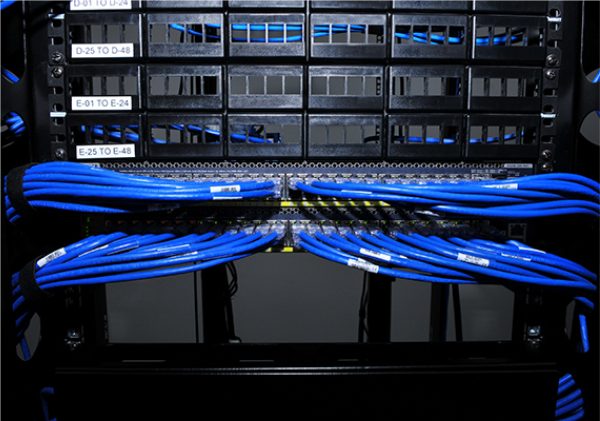 Asset-32@3x-100.jpg group of blue ethernet cables plugged in