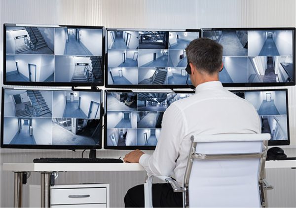 an employee viewing security cameras on monitors
